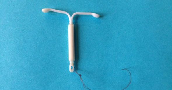 Mirena IUD, a form of long-acting, reversible contraception, on blue background